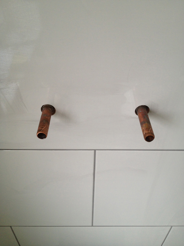 Copper Pipes Protruding From Wall