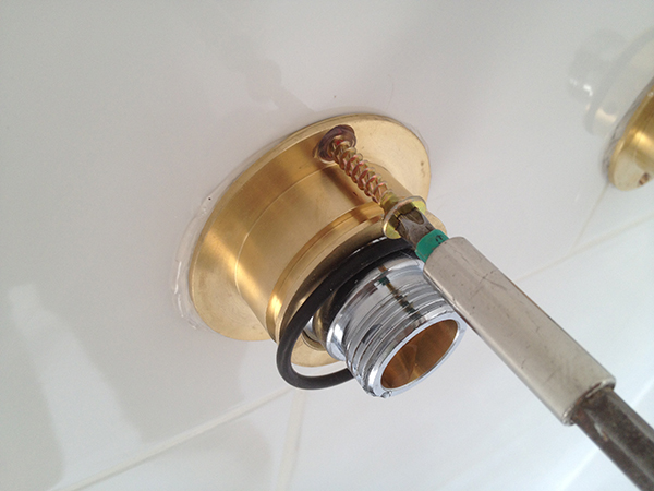 Screwing The Mounting Plate To The Wall With Bathroom Installation In Leeds