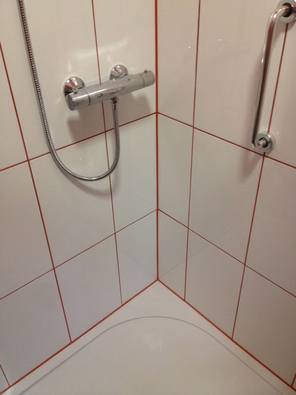 White Tiles With Red Silicone And Grout With Bathroom Installation In Leeds