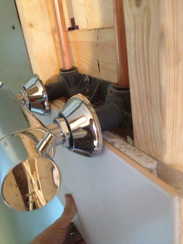 Checking The Position Of A Shower Bracket With Bathroom Installation In Leeds