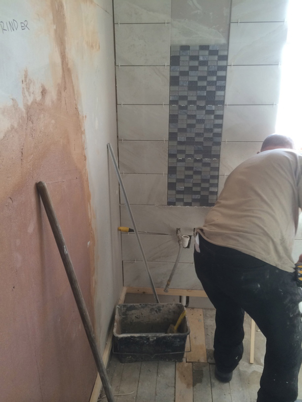 Wall Tiling In Progress With Bathroom Installation In Leeds