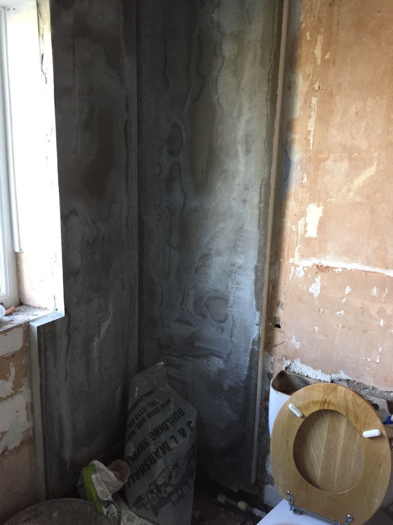 installing insulation boards in a bathroom