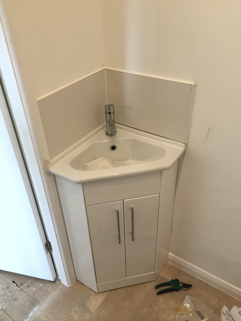 Corner basin vanity unit