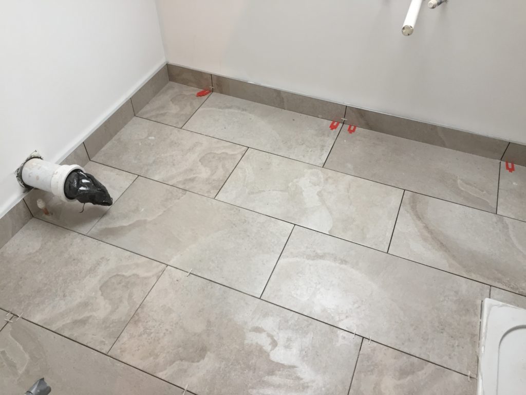 Floor tiling with upstands